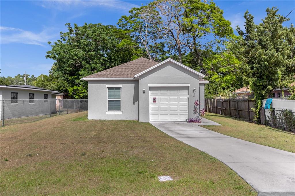 A single-story gray house with a white garage door and a concrete driveway — 97 N GOLDWYN AVENUE, ORLANDO, FL