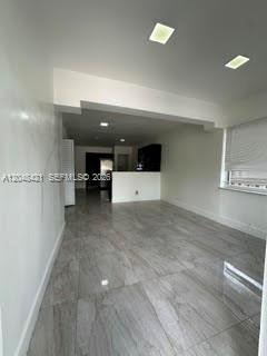 An interior view of a room with gray tile flooring and recessed ceiling lights — 3411 NW 9th Ct # B, Miami FL 33127, MIAMI, FL