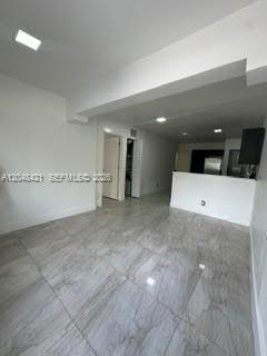 An interior view of a room with light gray tile flooring and white walls — 3411 NW 9th Ct # B, Miami FL 33127, MIAMI, FL