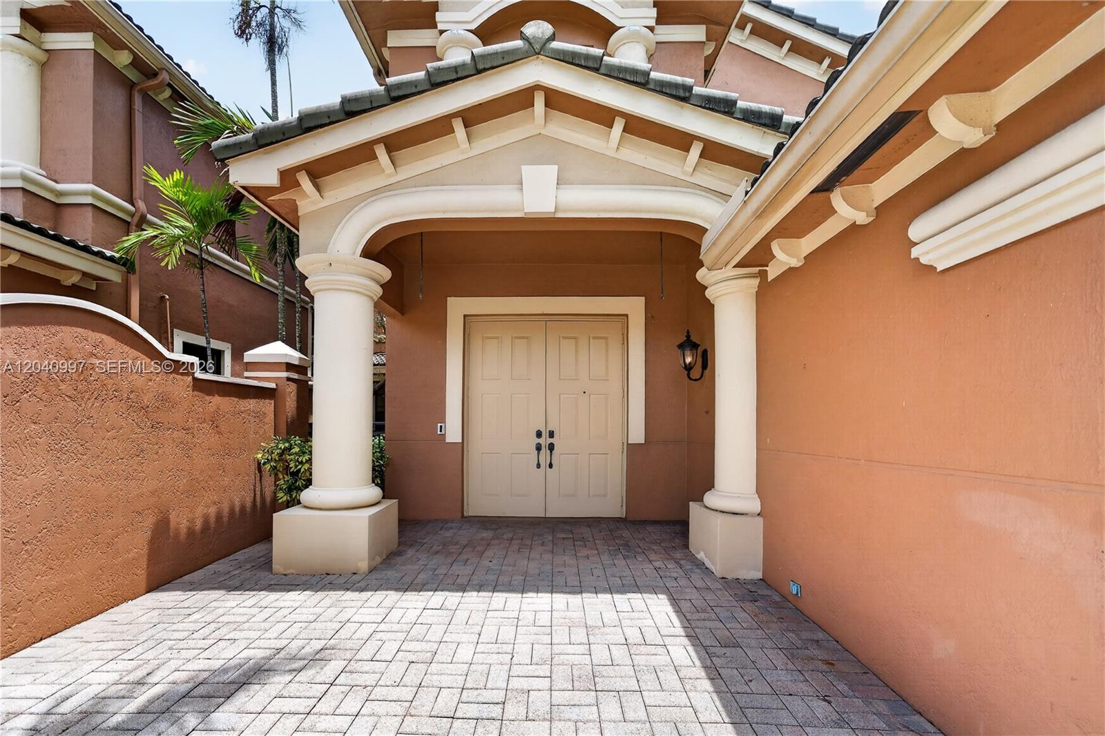 A paved entryway features double doors framed by two large white columns under a roof — 2767 Kinsington Cir # 4, Weston FL 33332, WESTON, FL