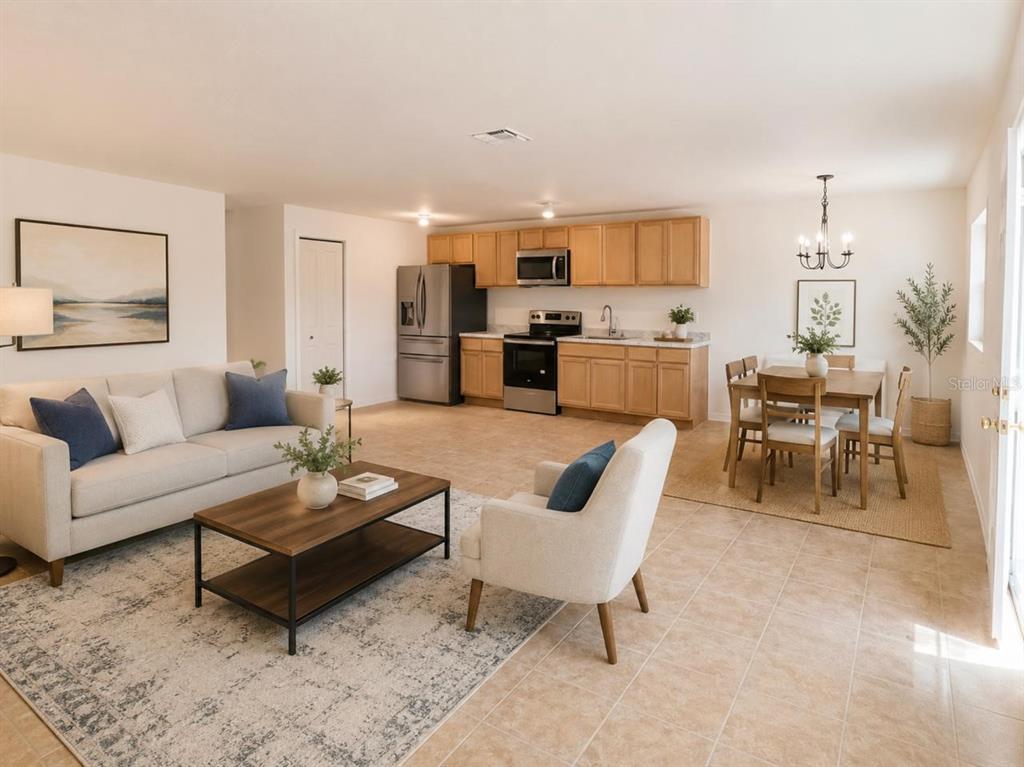 An open-concept living room and kitchen featuring light wood cabinets and tile flooring — 301 CLARK STREET UNIT 2, MAITLAND, FL