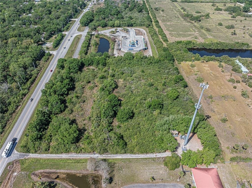 An aerial view shows a large, wooded lot with a cell tower and adjacent road — 0 Cr 512, Fellsmere FL 32948, FELLSMERE, FL