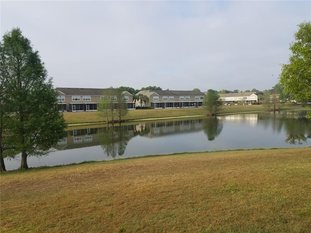 A view of a pond with multi-story apartment buildings in the background — 4238 SW 50TH CIRCLE, OCALA, FL