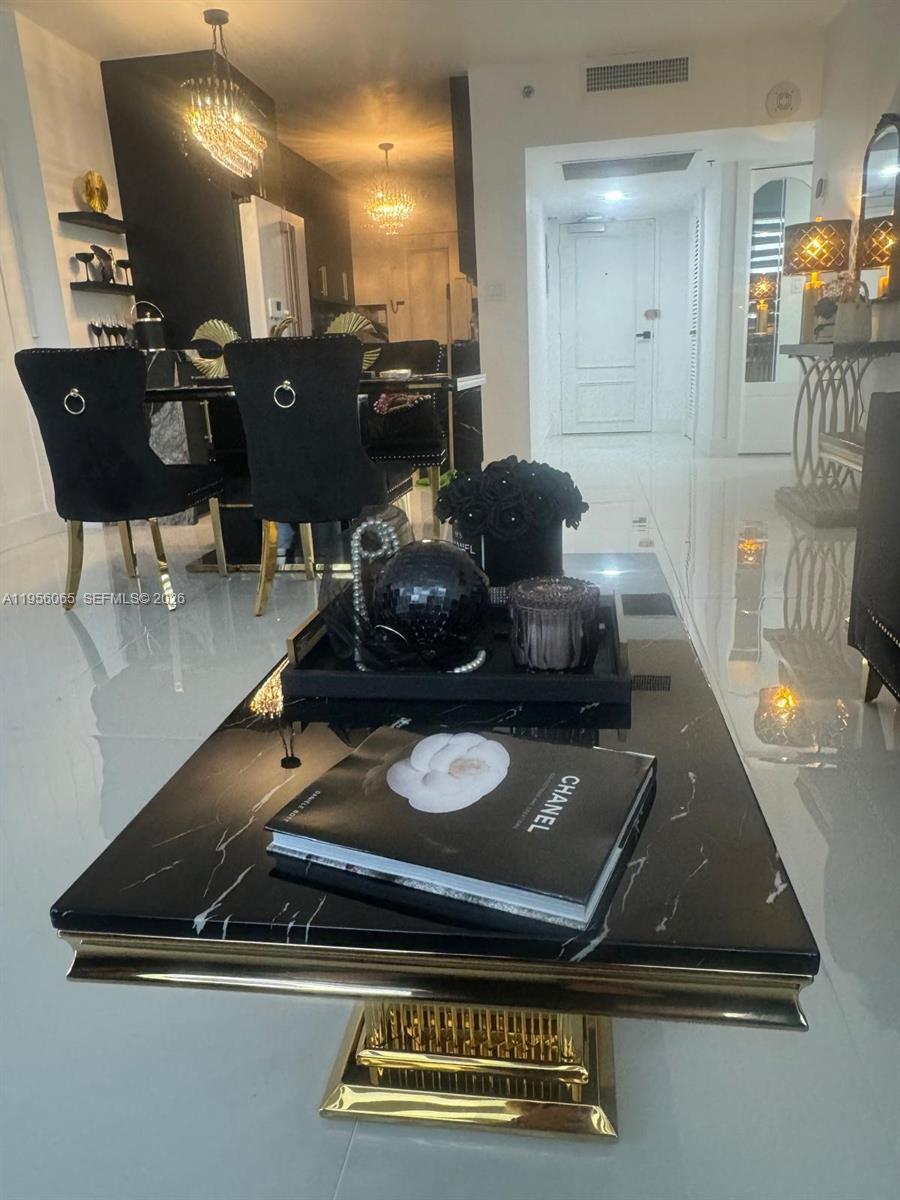 A modern living and dining area features a black marble coffee table and black chairs — 100 Lincoln Rd # 408, Miami Beach FL 33139, MIAMI BEACH, FL