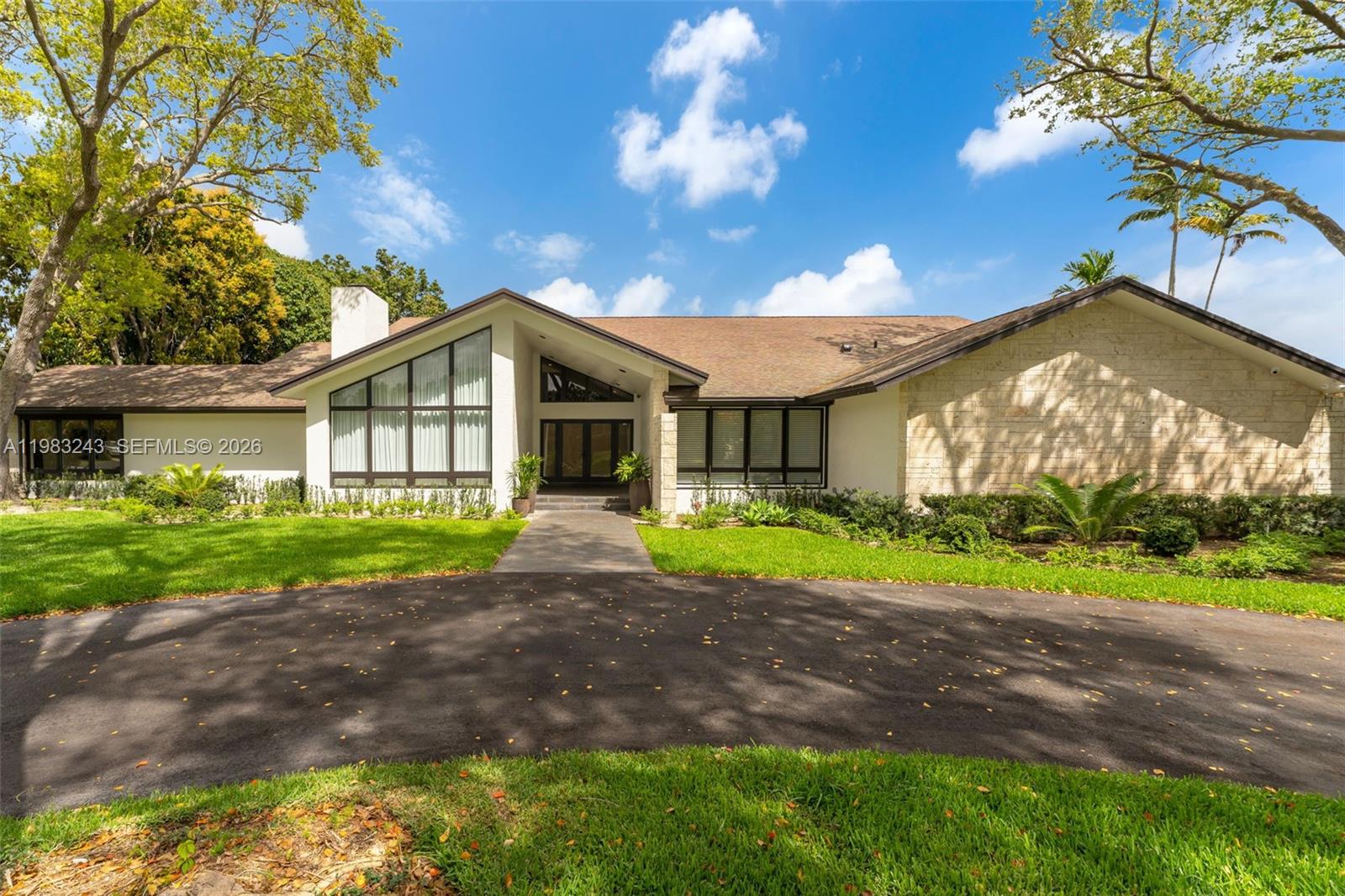 A single-story house with a stone facade, large windows, and a paved driveway — 8967 SW 117th St, Miami FL 33176, MIAMI, FL