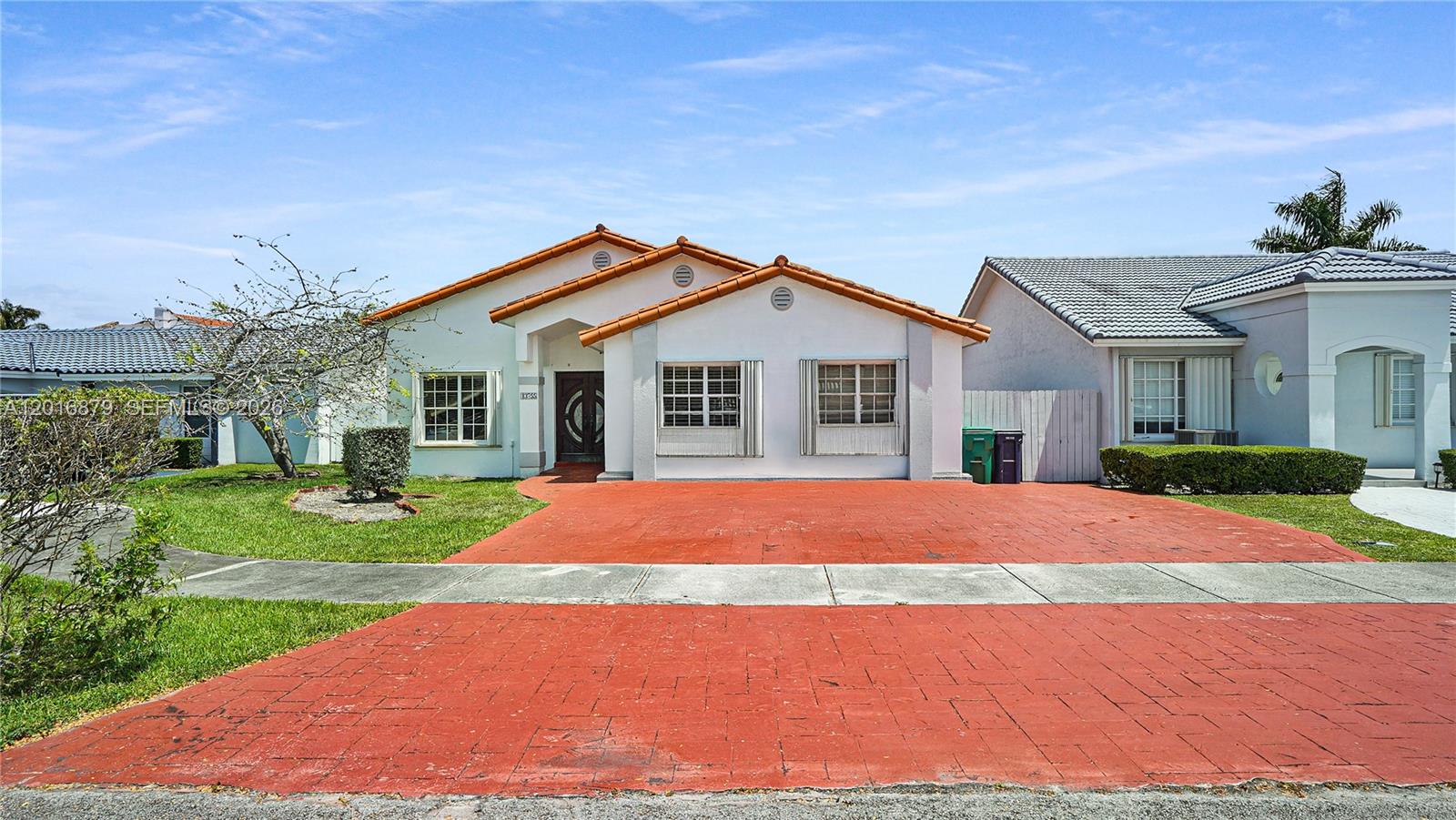 A single-story house with a red-tiled roof and a red-paved driveway faces the street — 13755 SW 19th Ter, Miami FL 33175, MIAMI, FL
