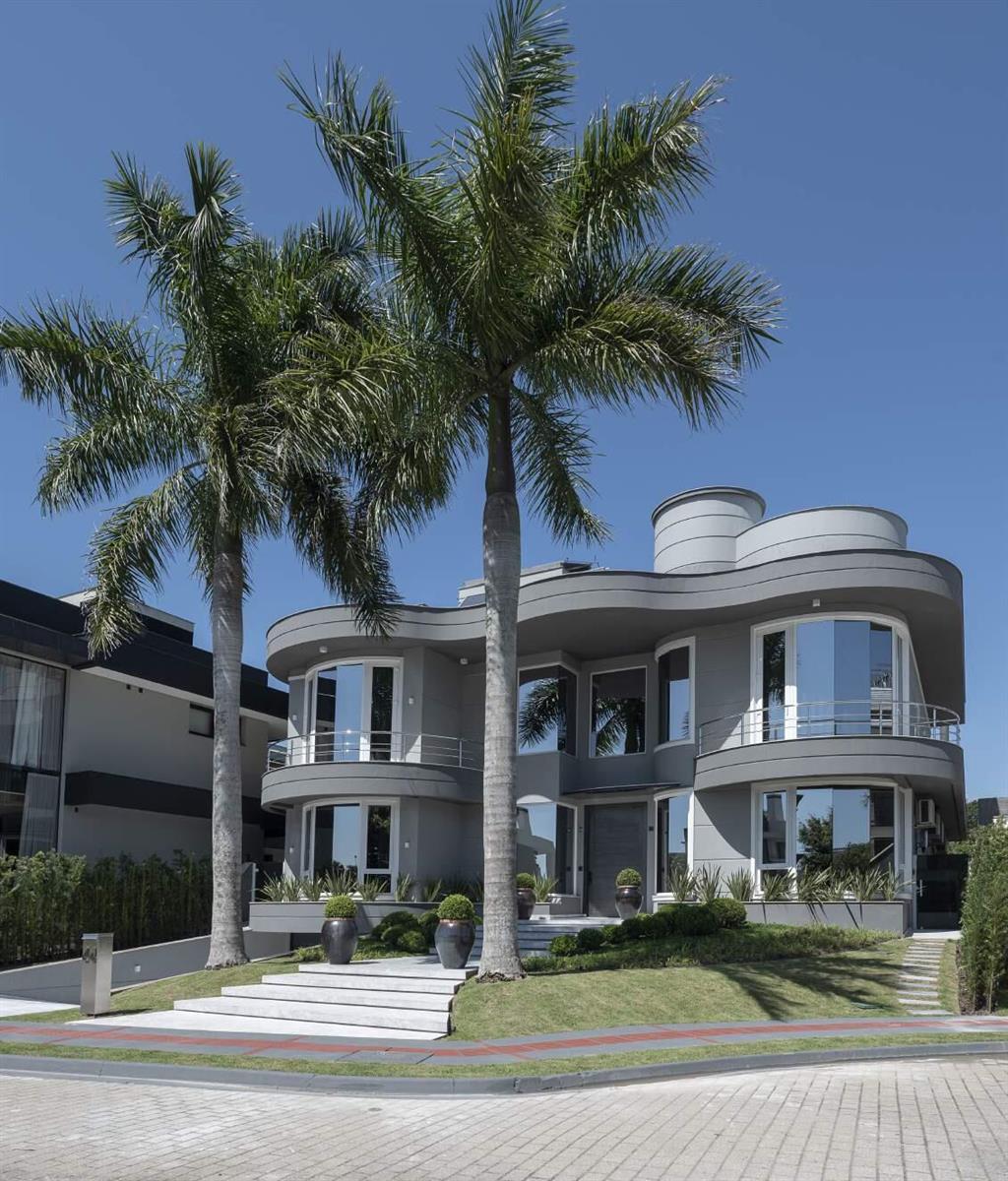 A modern two-story gray house with curved walls and two tall palm trees in front — 44 Rua Das Pirapemas Street # 44, FL
