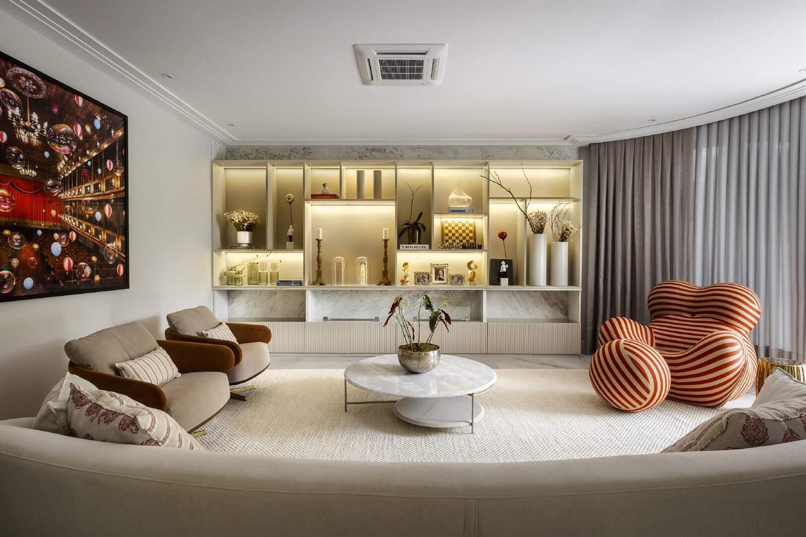 A living room features a marble-backed shelving unit, a round coffee table, and striped armchair — 44 Rua Das Pirapemas Street # 44, FL