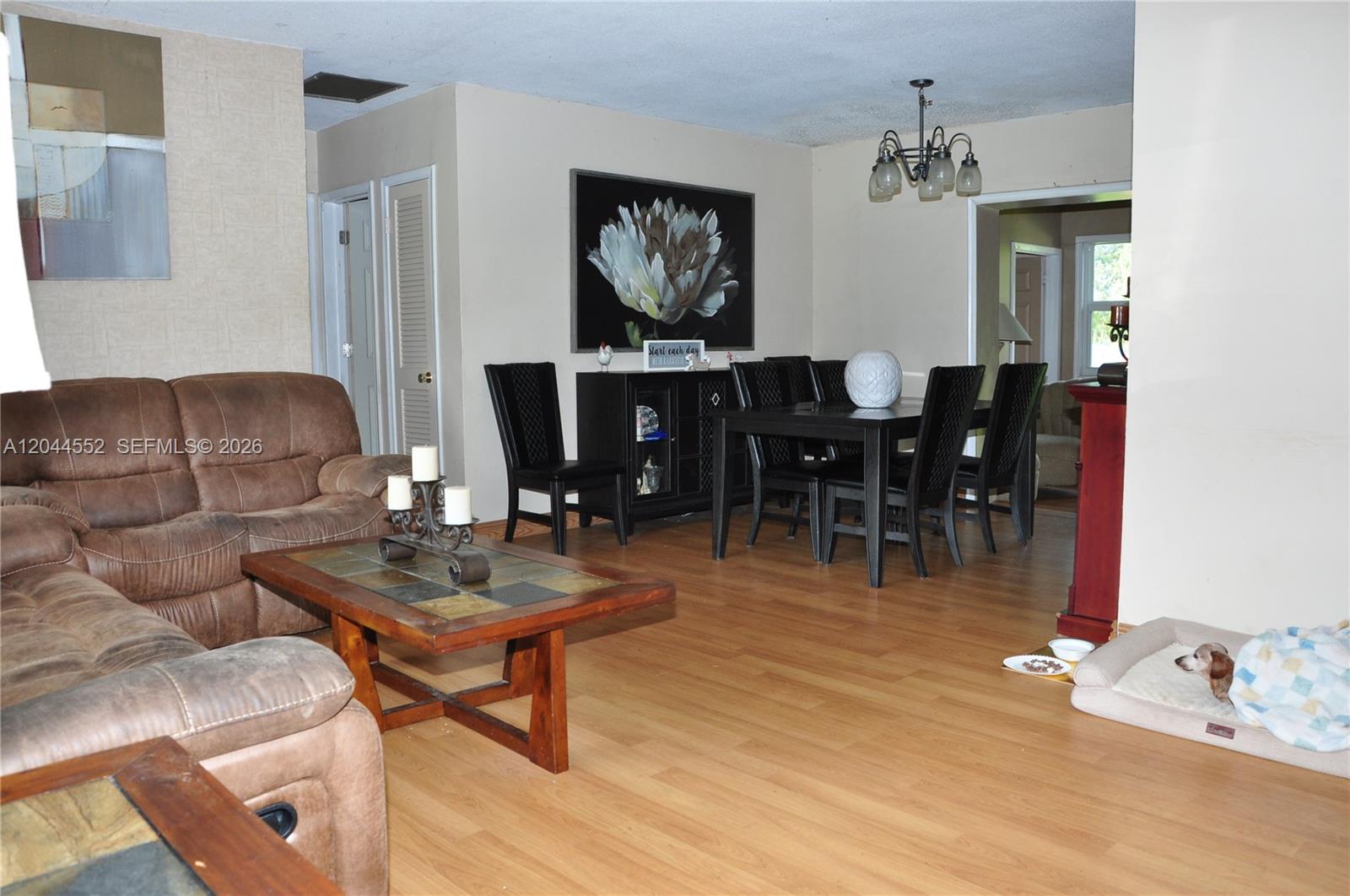 A living and dining area features brown leather furniture, a wooden coffee table, and flooring — 5630 SW 55th Ave, Davie FL 33314, DAVIE, FL