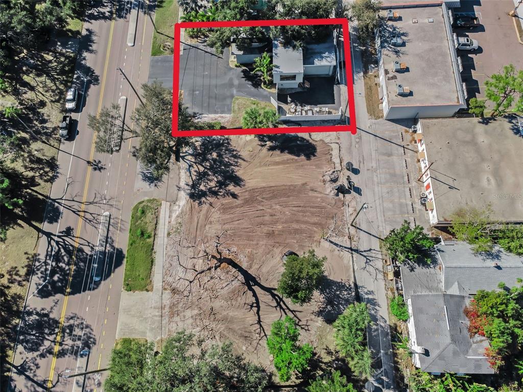 An aerial view shows a small building outlined in red next to a cleared lot — 7321 1ST AVENUE S, ST PETERSBURG, FL
