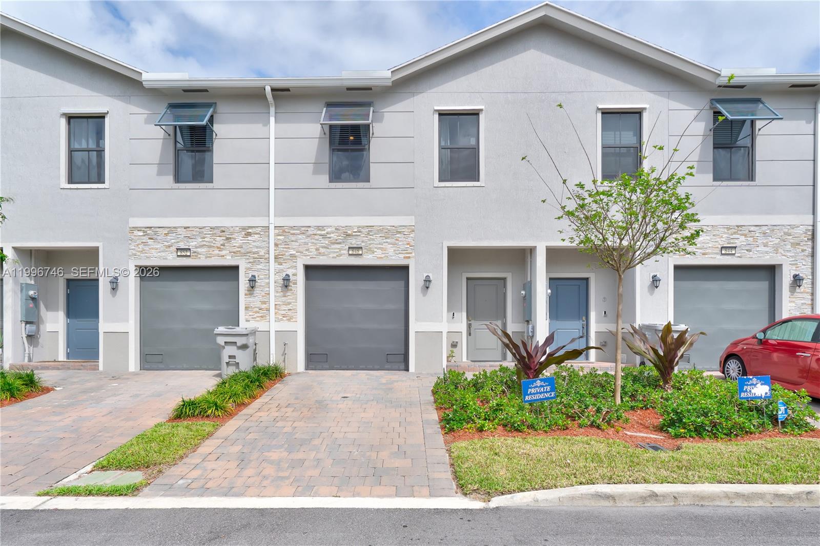 An aerial view shows a residential complex of white townhouses surrounding a central retention pond — 848 NW 3rd Ter, Pompano Beach FL 33060, POMPANO BEACH, FL