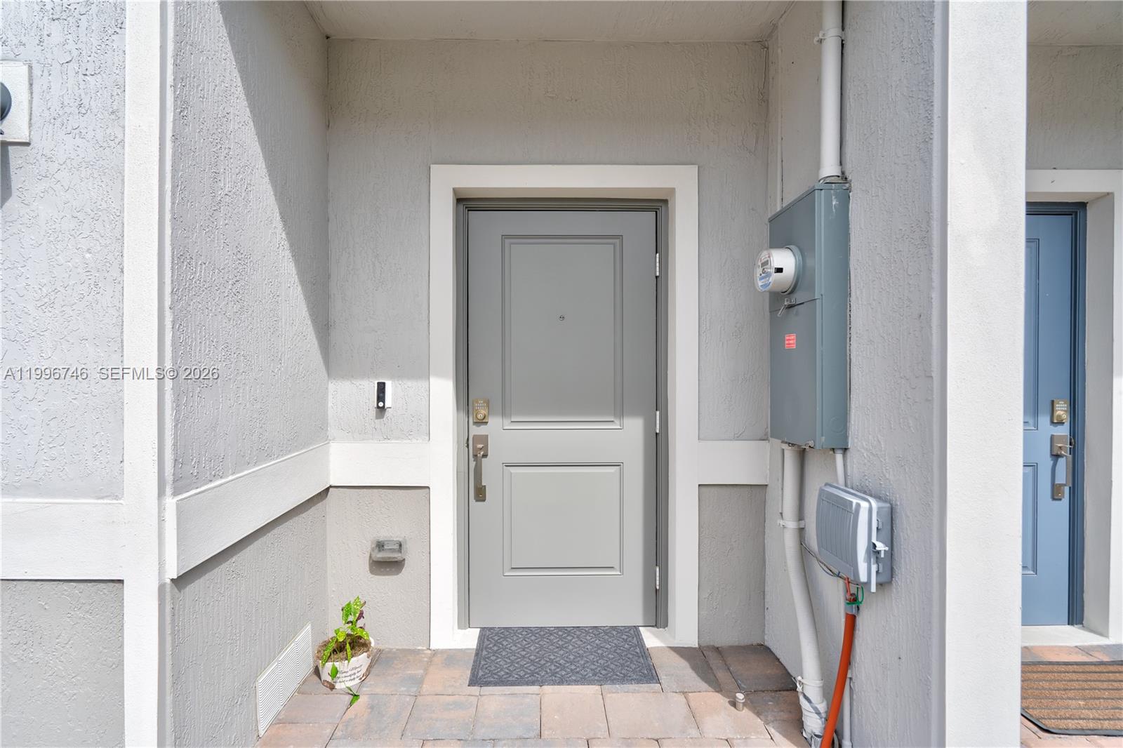 A row of modern townhouses features gray garage doors, stone accents, and paved driveways — 848 NW 3rd Ter, Pompano Beach FL 33060, POMPANO BEACH, FL