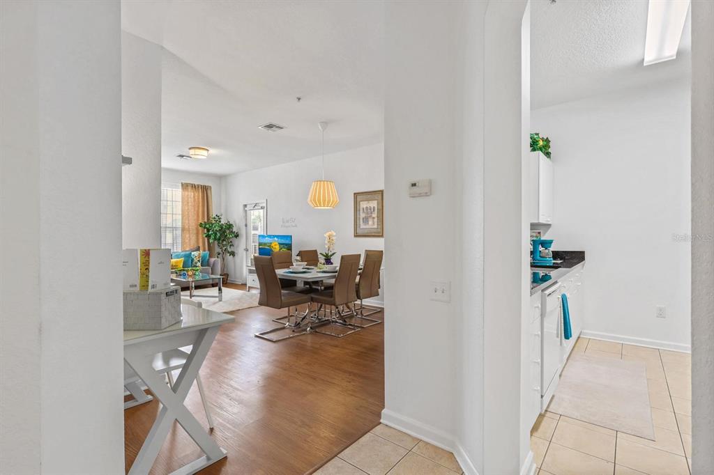 A view from a tiled entryway looking into a dining area and living room — 2310 SILVER PALM DRIVE UNIT 201, KISSIMMEE, FL