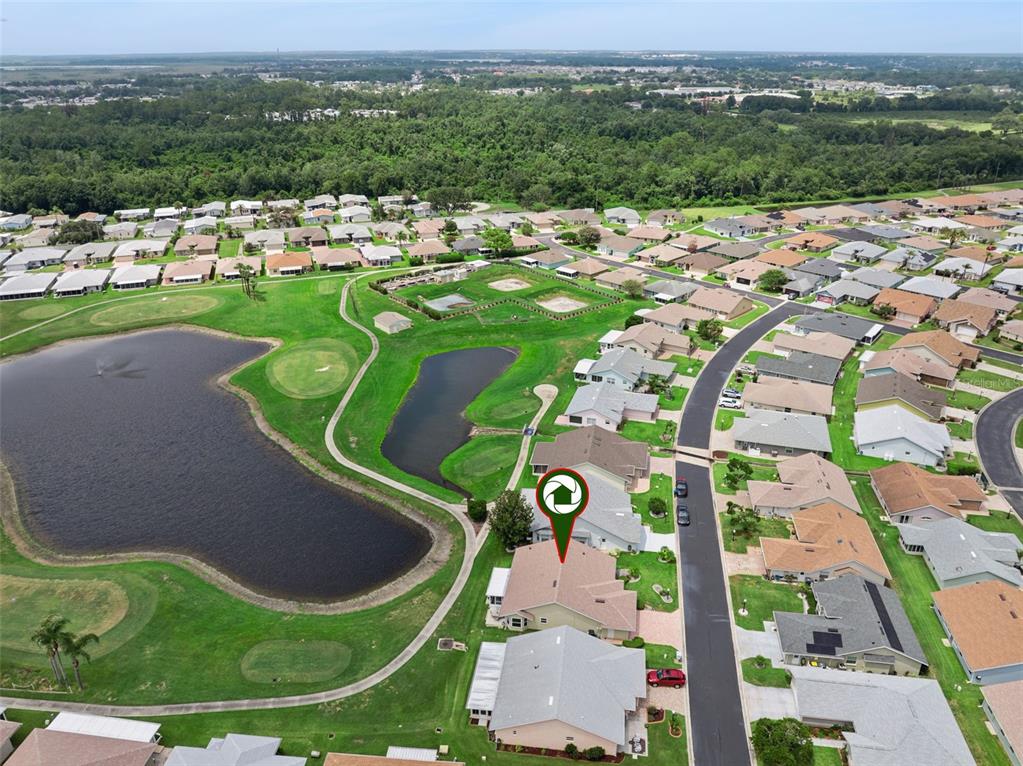Aerial view of a suburban neighborhood with houses surrounding a golf course and ponds — 501 EASTLAKE DRIVE, HAINES CITY, FL