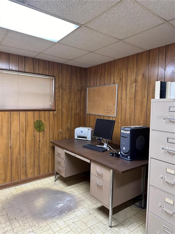 A small office features wood-paneled walls, a desk with computer equipment, and a metal filing cabinet — 602 HATHAWAY AVENUE, BRONSON, FL