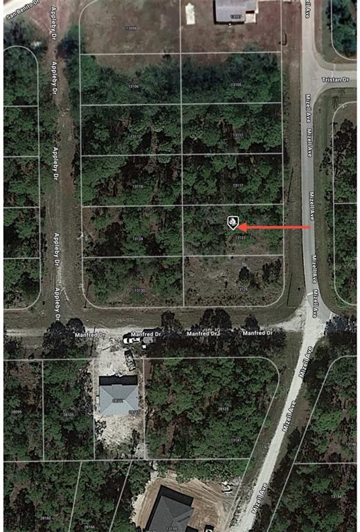 This is an aerial map showing a vacant residential lot highlighted with a red arrow — 13123 MIZELL AVENUE, PUNTA GORDA, FL