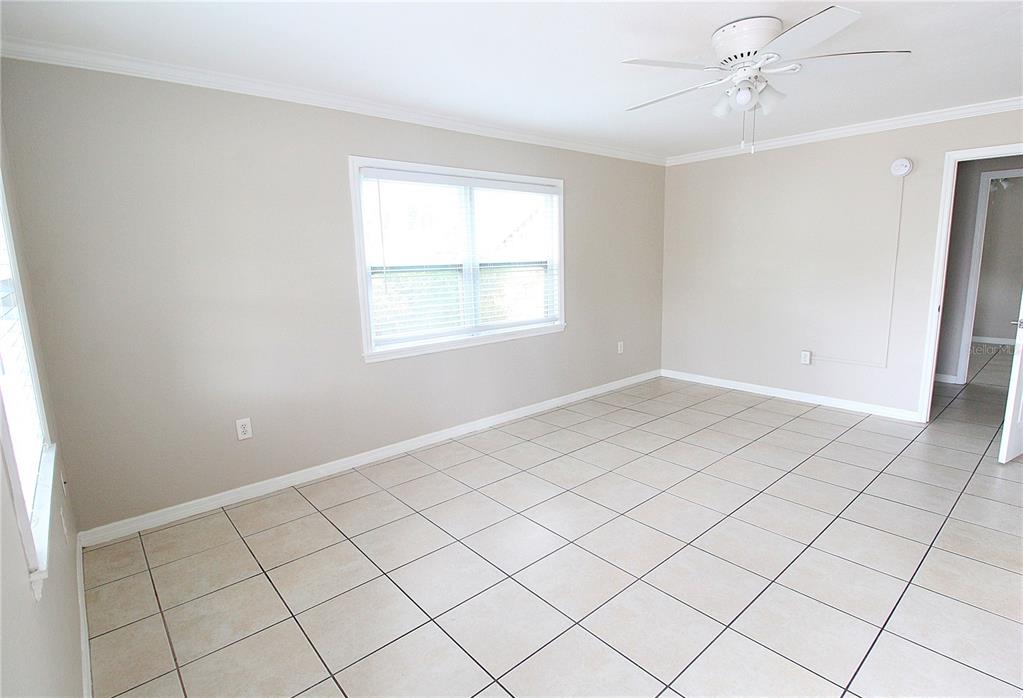 An empty room with beige walls, tile flooring, and a ceiling fan — 1638 REDWOOD STREET UNIT 1, SARASOTA, FL