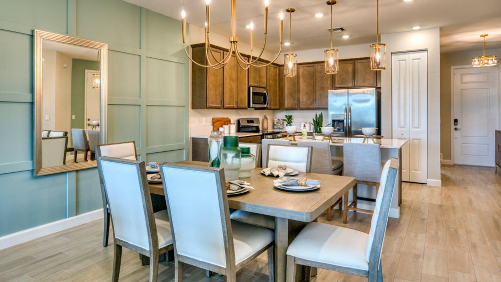 A dining area with a green paneled wall and chandelier opens into a wood-cabinet kitchen — 13658 Jubilee Lane, Delray Beach FL 33484, DELRAY BEACH, FL