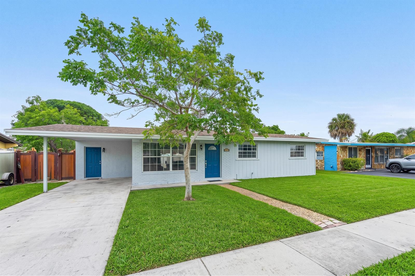 A single-story house with a light blue exterior, a carport, and a front lawn — 5543 SW 7th Street, Margate FL 33068, MARGATE, FL