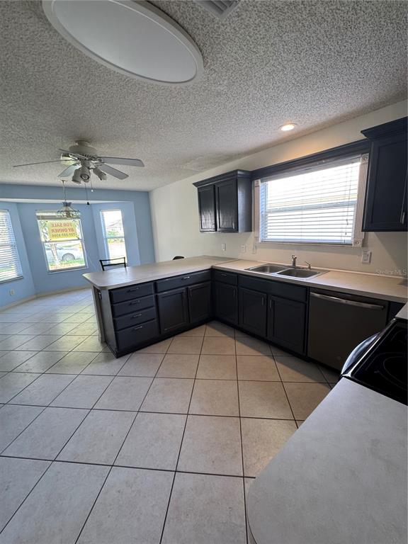 A single-story house with yellow siding, a brown shingled roof, and a front garden bed — 1033 OAK FOREST DRIVE, THE VILLAGES, FL