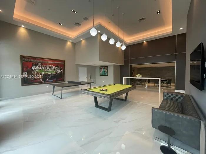 A spacious game room features a pool table, ping pong table, and modern pendant lighting — 1000 NW 7th St # 710, Miami FL 33136, MIAMI, FL