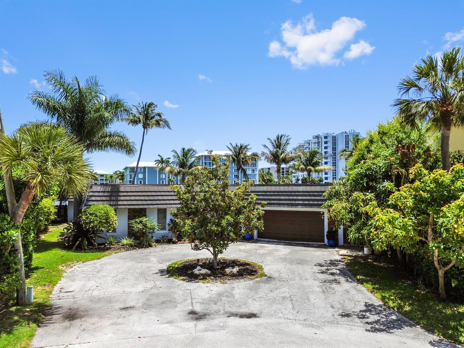 A single-story house with a circular driveway, a central tree, and a two-car garage — 976 Banyan Drive, Delray Beach FL 33483, DELRAY BEACH, FL