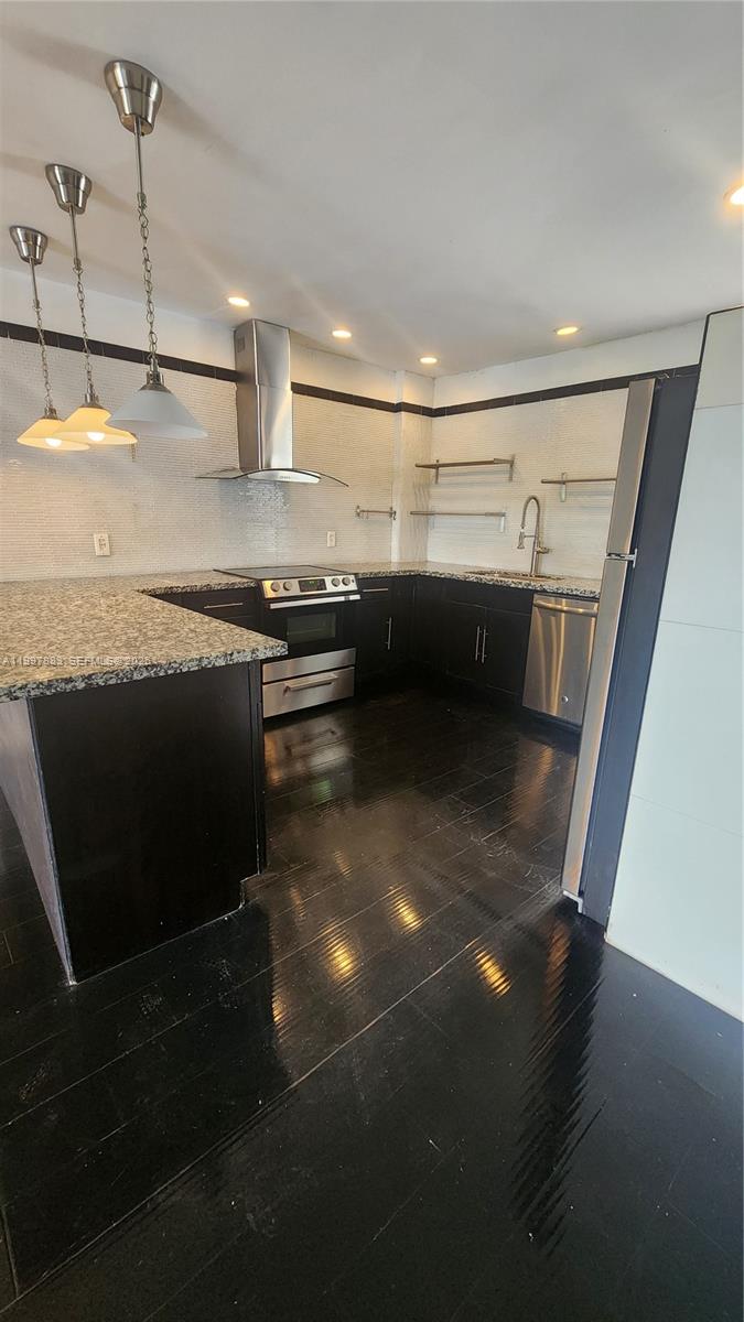 A kitchen features dark cabinets, granite countertops, stainless steel appliances, and a tiled backsplash — 3811 NW 84th Ave # 2B, Sunrise FL 33351, SUNRISE, FL