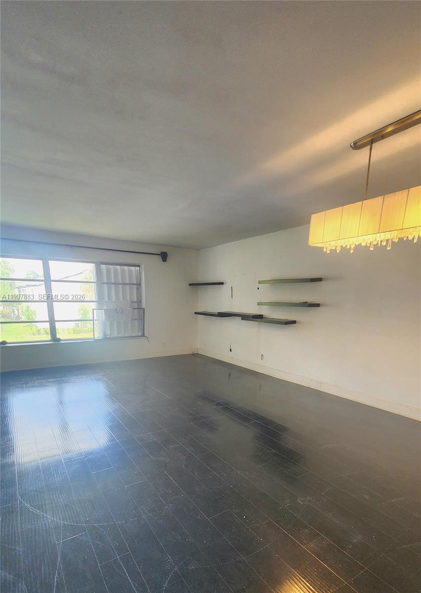 A kitchen features black cabinets, granite countertops, stainless steel appliances, and a white tiled backsplash — 3811 NW 84th Ave # 2B, Sunrise FL 33351, SUNRISE, FL