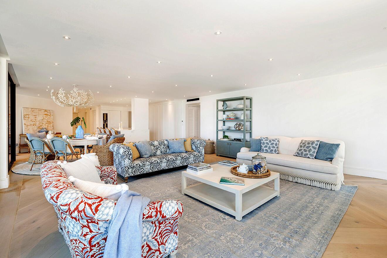 A bright living room features patterned sofas, a light wood coffee table, and a dining area — 3300 S Ocean Boulevard # 305n, Palm Beach FL 33480, PALM BEACH, FL