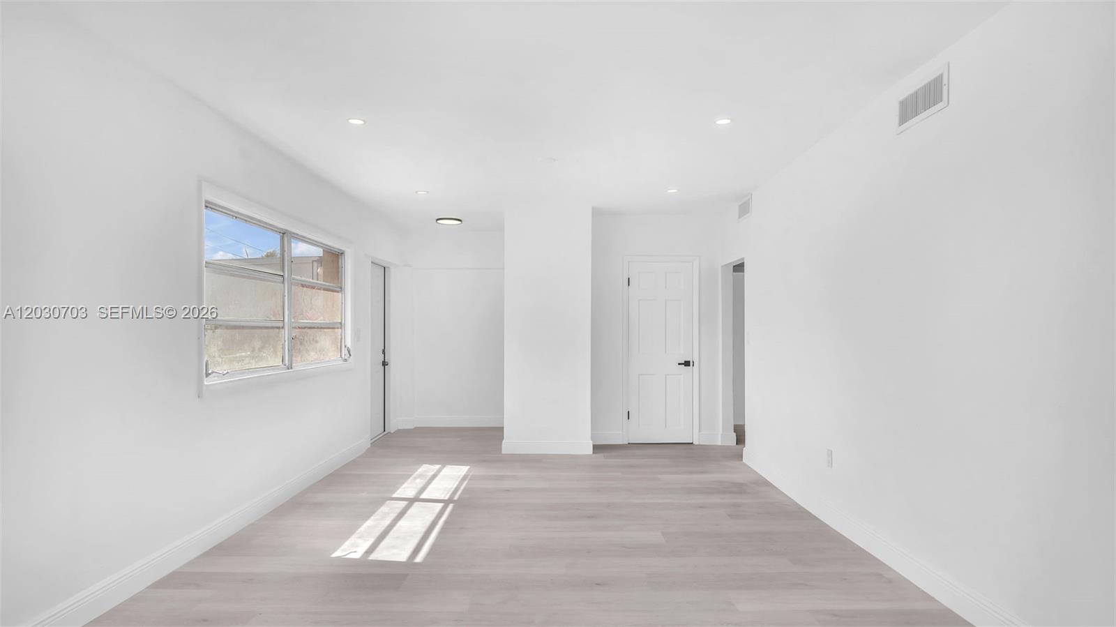 A bright, empty room features white walls, recessed lighting, and light-colored wood-look flooring — 1365 NW 55th Ter # B, Miami FL 33142, MIAMI, FL