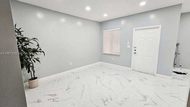 A room with light gray walls, white marble-patterned tile flooring, a potted plant, and a door — 11275 SW 231st Ln, Miami FL 33170, MIAMI, FL