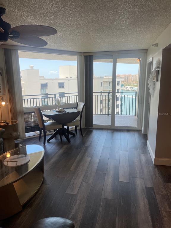 A dining area with a small table and chairs sits beside a balcony with water views — 690 ISLAND WAY UNIT 1112, CLEARWATER BEACH, FL