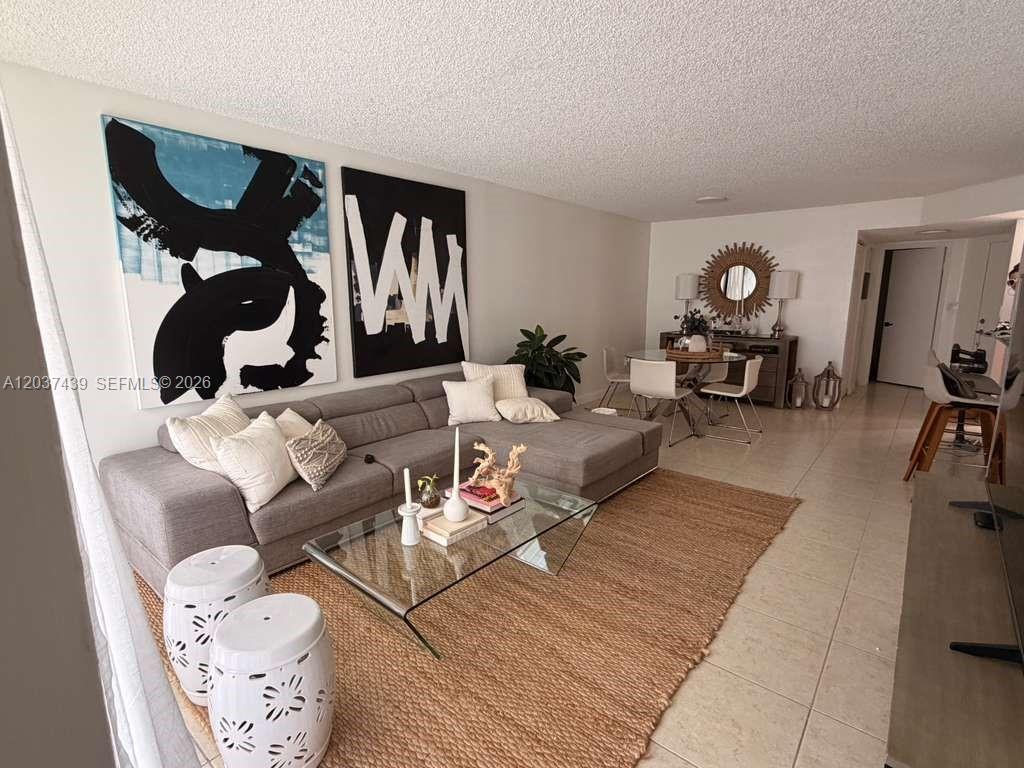 A living room features a gray sectional sofa, a glass coffee table, and large abstract art — 4733 NW 97th Ct # 45, Doral FL 33178, DORAL, FL