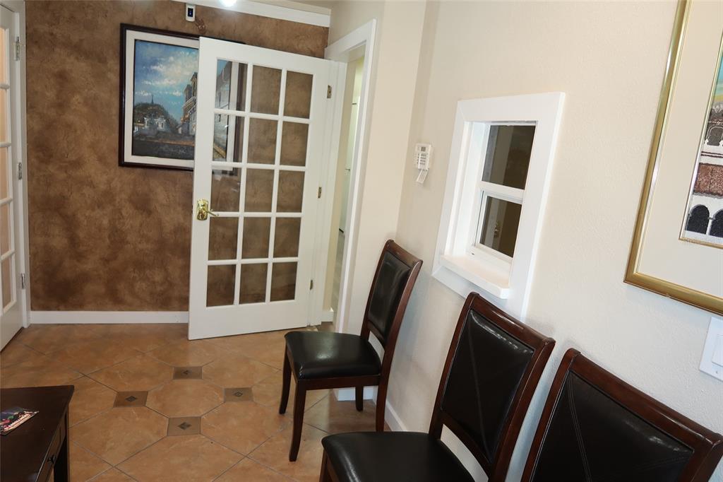 A waiting area features tile flooring, dark leather chairs, a French door, and wall art — 448 S ALAFAYA TRAIL UNIT 4, ORLANDO, FL