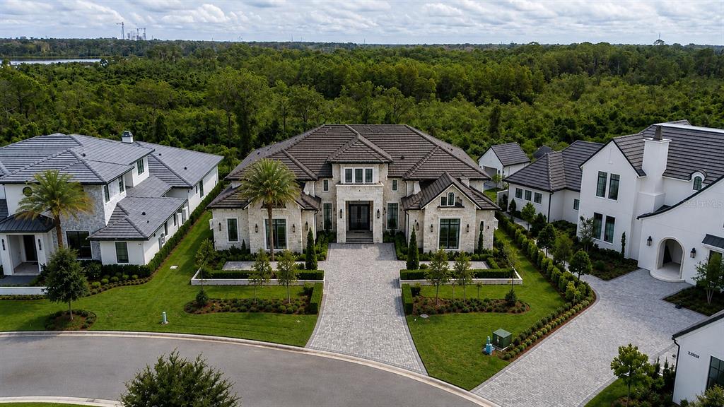 An aerial view of a large stone house with a dark tile roof and driveway — LOT 41, CROMWELL ROAD, ORLANDO, FL