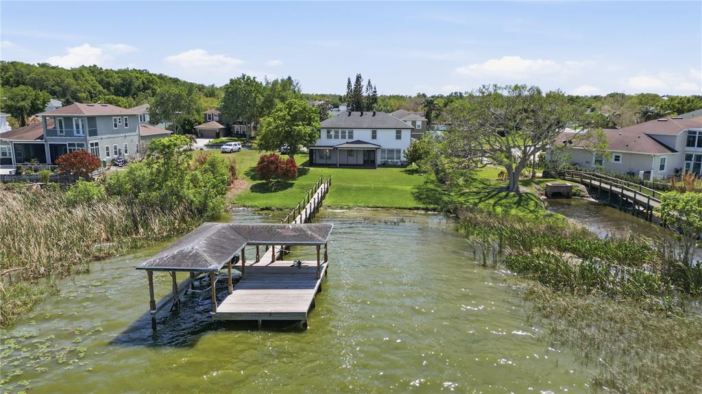An aerial view shows a house with a lawn, a wooden dock, and a boat slip — 243 ZACHARY WADE STREET, WINTER GARDEN, FL