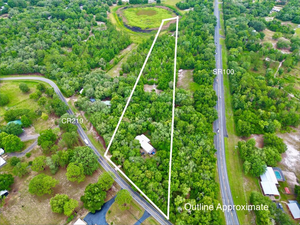 An aerial view shows a triangular wooded lot bordered by two roads — 5918 COUNTY ROAD 219, MELROSE, FL