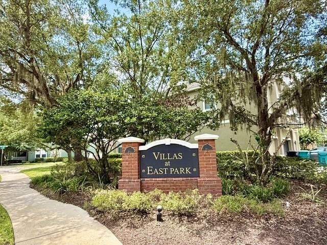 A brick sign for Villas at East Park stands in front of trees and buildings — 10378 LAKE DISTRICT LANE UNIT 2B, ORLANDO, FL