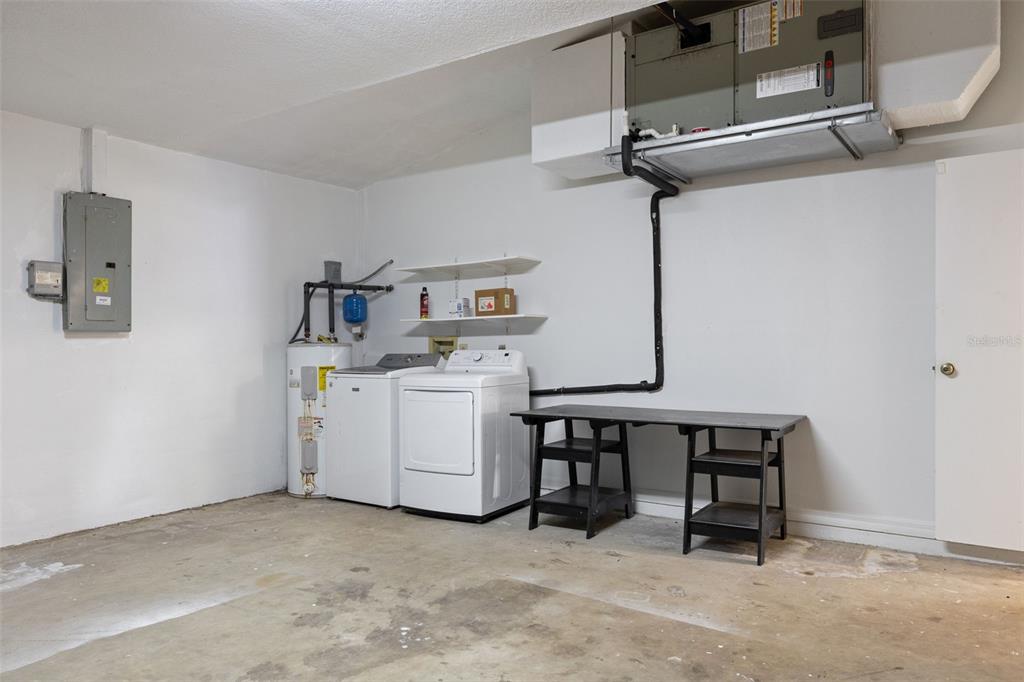 A garage utility area features a washer, dryer, water heater, and an HVAC unit — 23230 GOLDCOAST AVENUE, PUNTA GORDA, FL