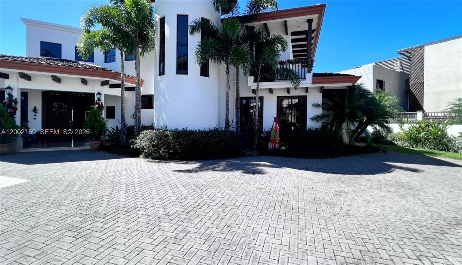 A white two-story house with a circular tower and a brick-paved driveway — Casa Guayabos Curridabat, San Jose, Costa Rica, FL, FL