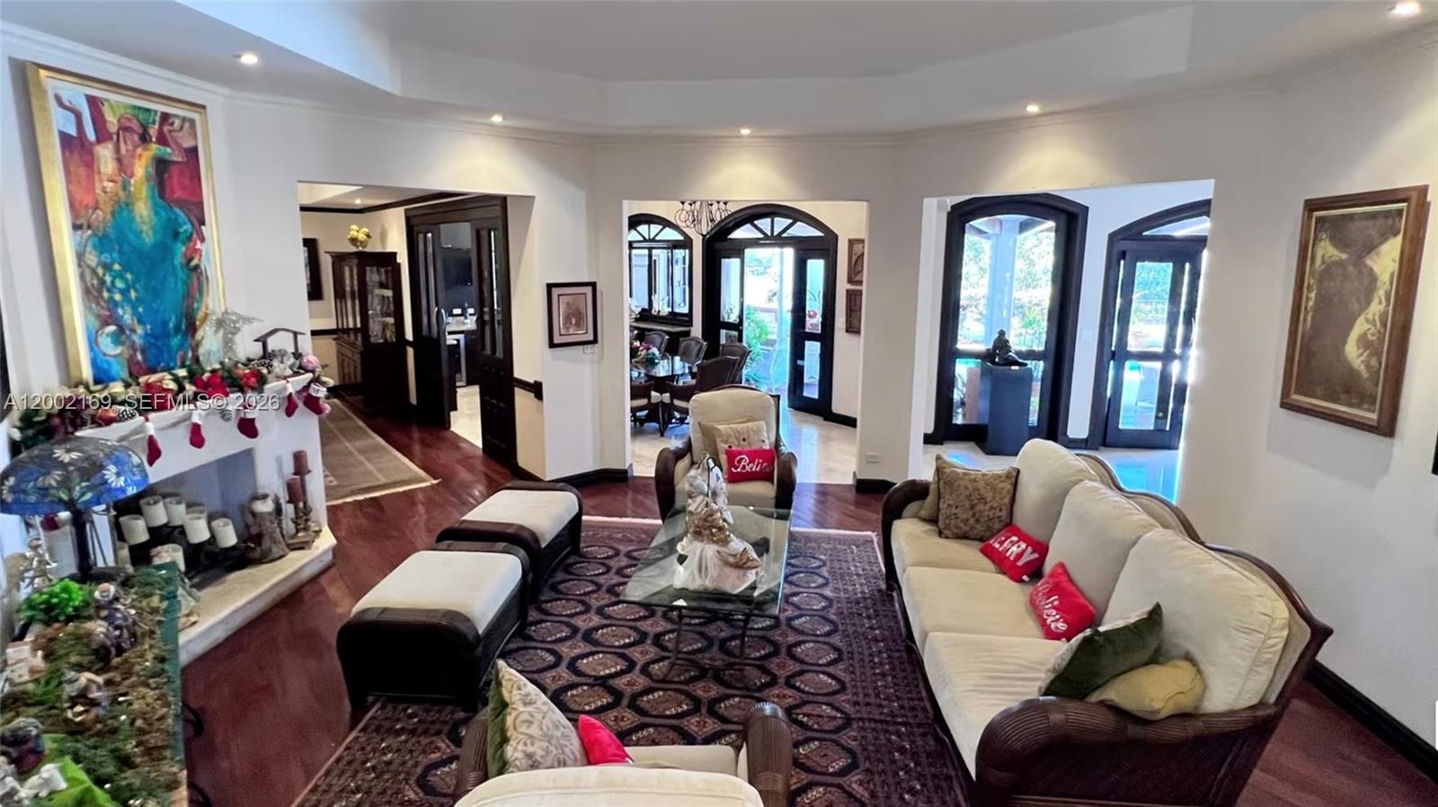 A living room features a fireplace, a large area rug, and multiple seating areas — Casa Guayabos Curridabat, San Jose, Costa Rica, FL, FL