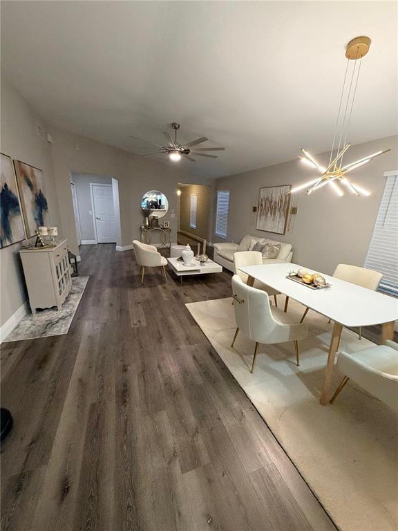 An open-concept dining and living area features wood-look flooring, modern lighting, and neutral furniture — 11331 PALM ISLAND AVENUE, RIVERVIEW, FL