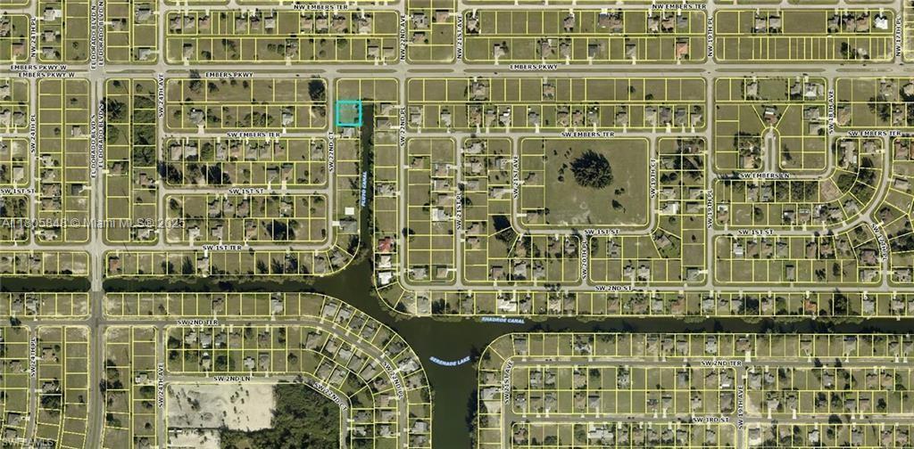 This is an aerial map showing a vacant residential lot highlighted in blue near a canal — 9 SW 22ND  CT, Cape Coral FL 33991, CAPE CORAL, FL