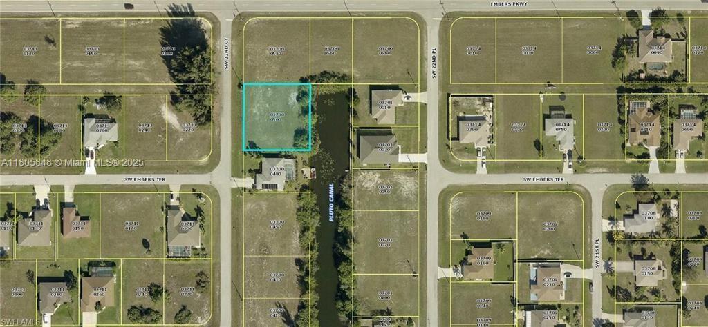 This is an aerial map showing a vacant residential lot highlighted in blue next to a canal — 9 SW 22ND  CT, Cape Coral FL 33991, CAPE CORAL, FL