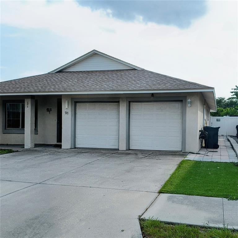 A single-story house features a two-car garage, a concrete driveway, and a small lawn — 1213 HUMBLE HAVEN STREET, RUSKIN, FL