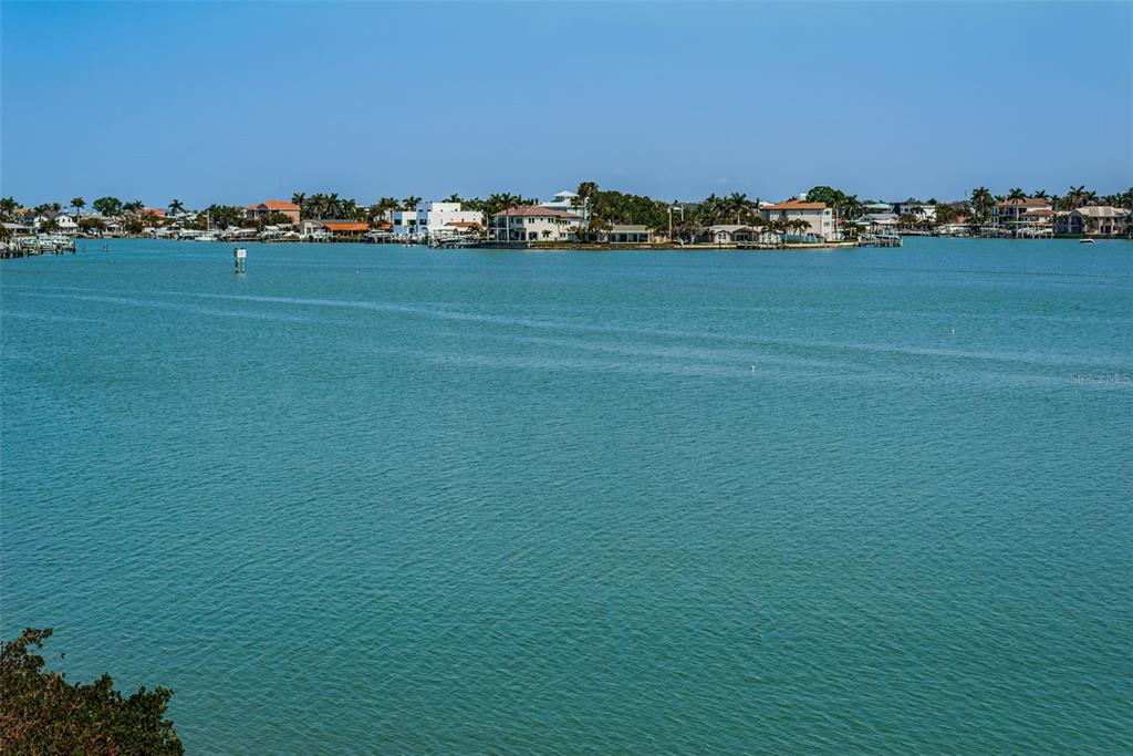 A wide view of a calm bay with waterfront houses and docks in the distance — 7979 SAILBOAT KEY BOULEVARD S UNIT 205, SOUTH PASADENA, FL