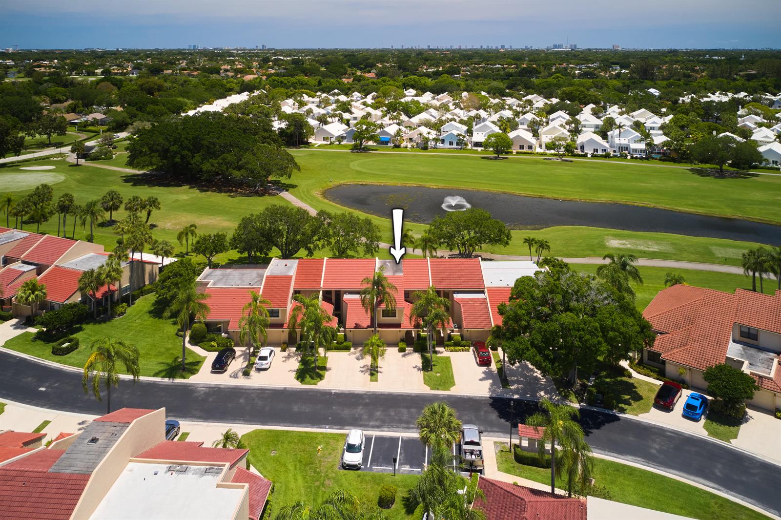 An aerial view shows a row of townhouses with red tile roofs overlooking a golf course — 832 Windermere Way, Palm Beach Gardens FL 33418, PALM BEACH GARDENS, FL