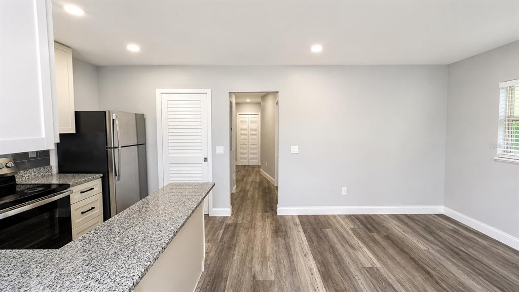 A kitchen with granite countertops, stainless steel appliances, and light gray walls — 2728 GOODRICH AVENUE, SARASOTA, FL