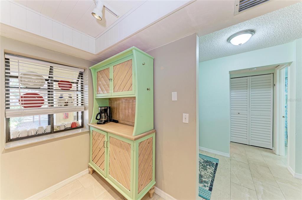 A light green hutch sits against a wall next to a window with blinds — 4412 SPICEWOOD DRIVE UNIT E, BRADENTON, FL