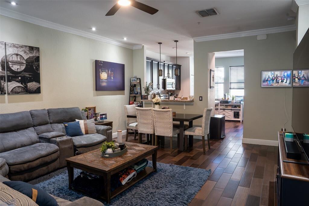 An open-concept living and dining area features a grey sofa, wooden coffee table, and kitchen — 2667 SW 118th Road, Miramar FL 33025, MIRAMAR, FL